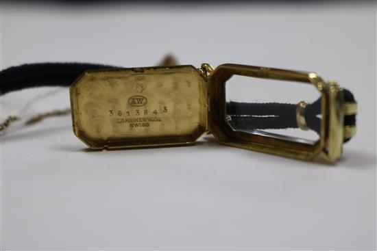 A ladys 18ct gold Longines manual wind wrist watch retailed by Tiffany & Co, on fabric strap.
